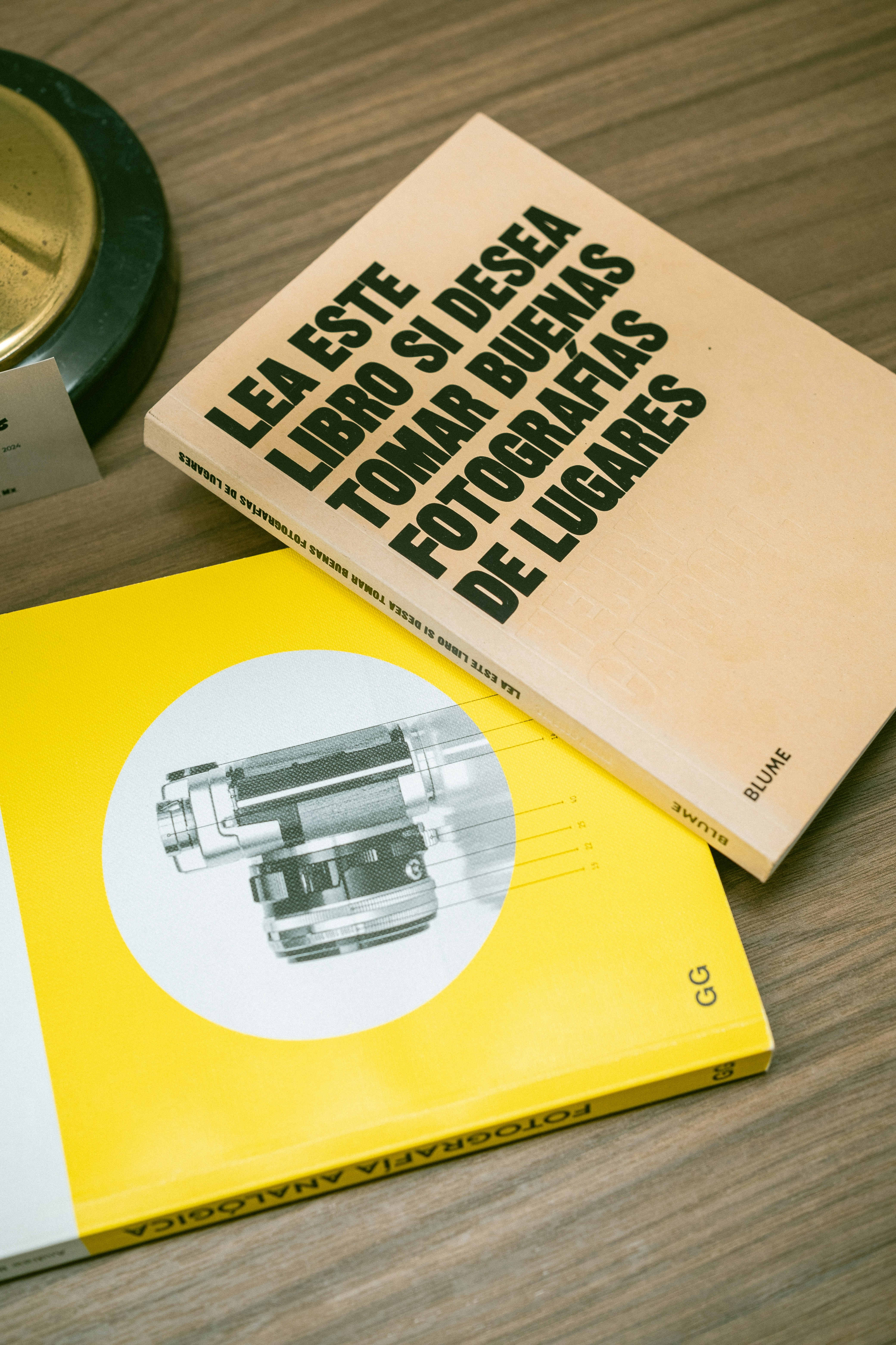A book sitting on top of a table next to a clock