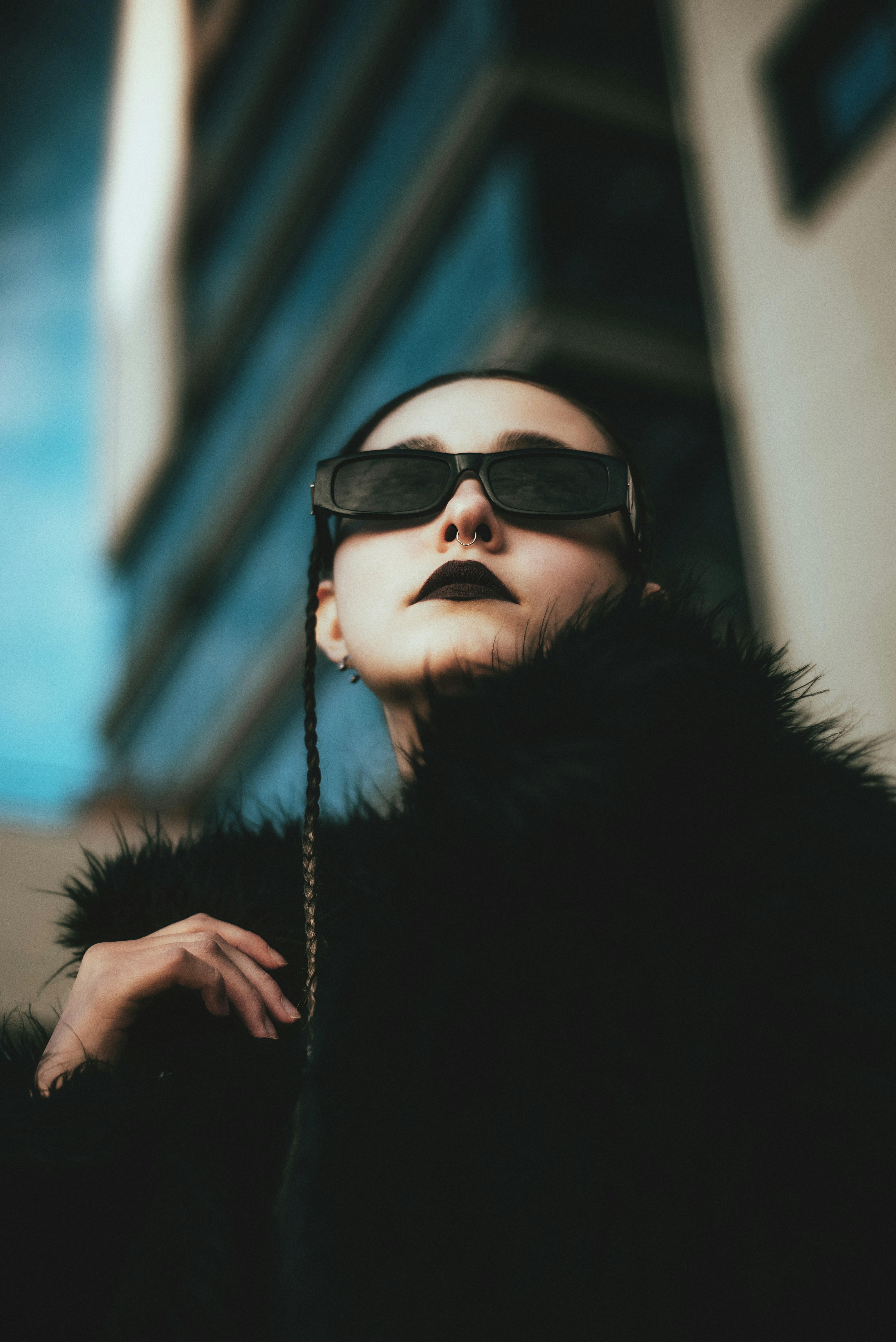 A woman wearing sunglasses and a fur coat