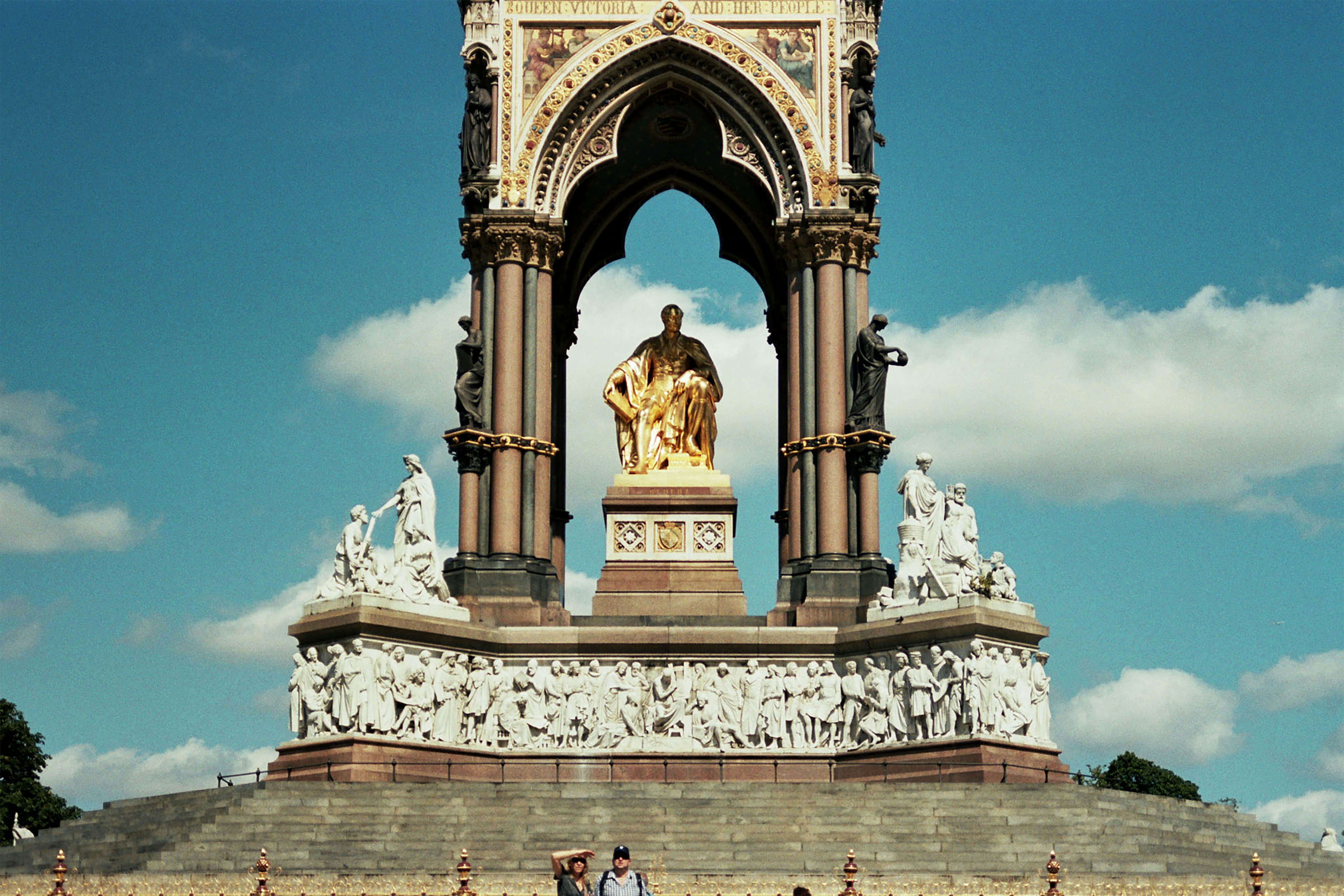 A group of people standing in front of a monument