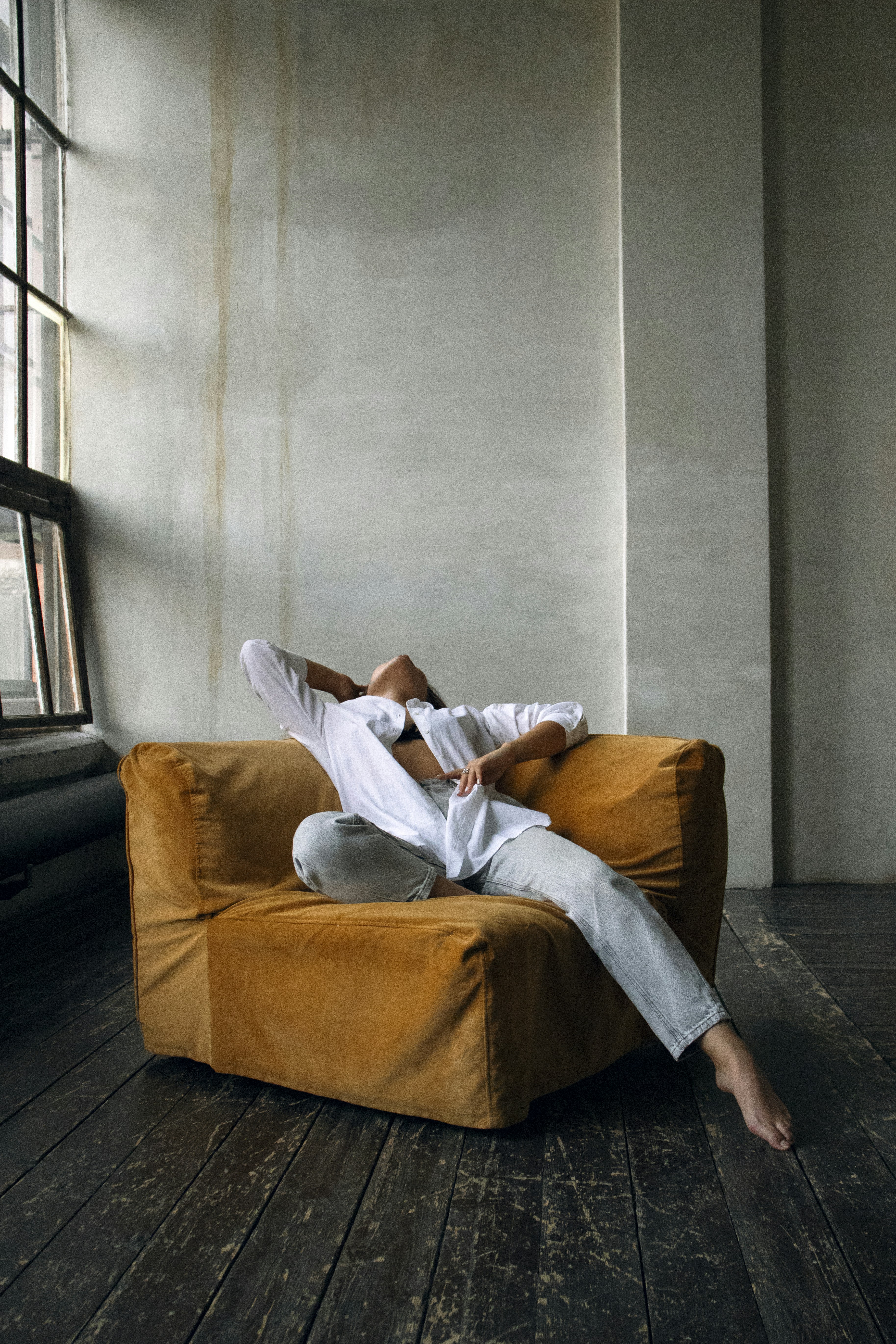 A person laying on a couch in a room