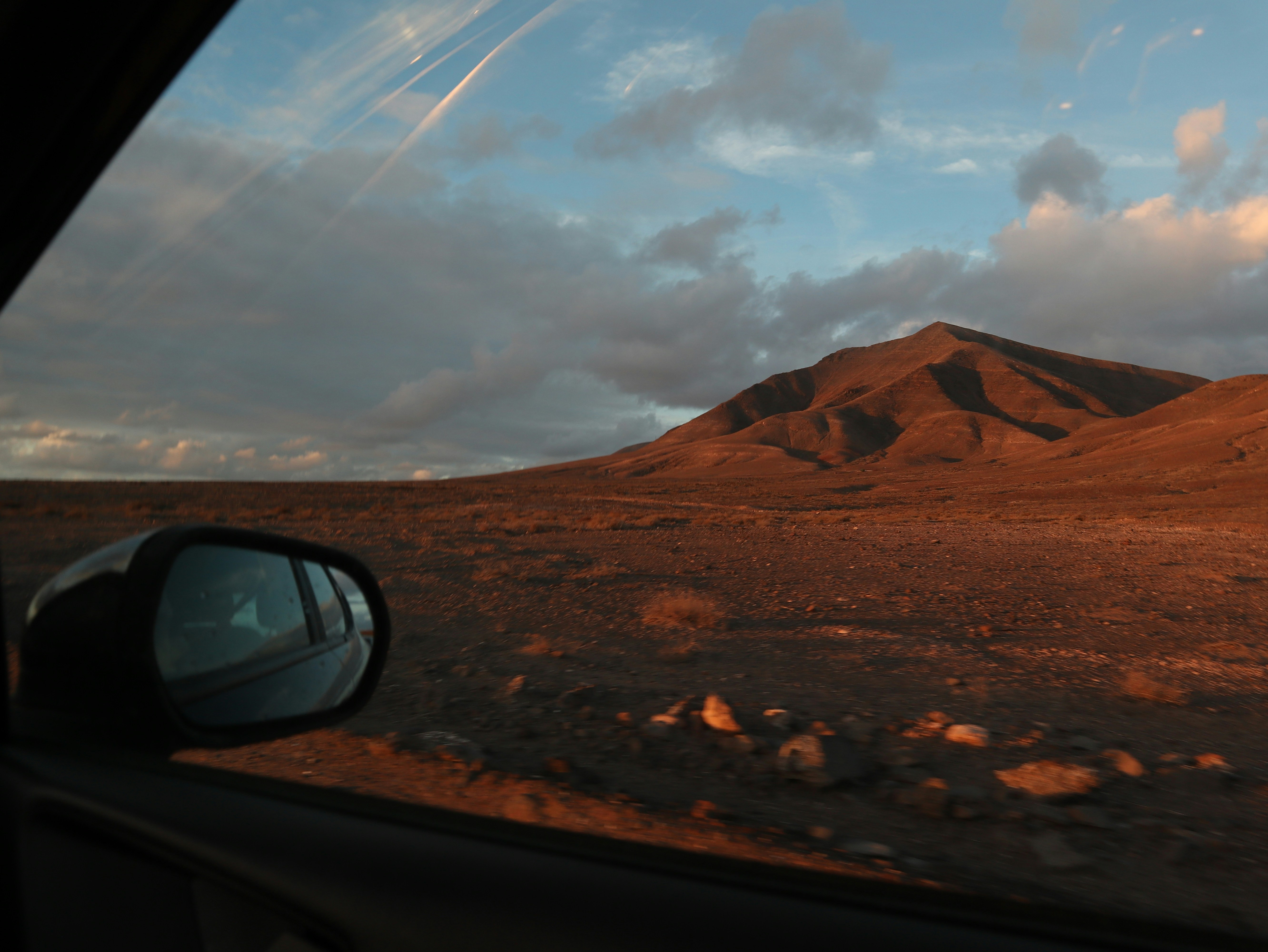 A view of a mountain from a car window