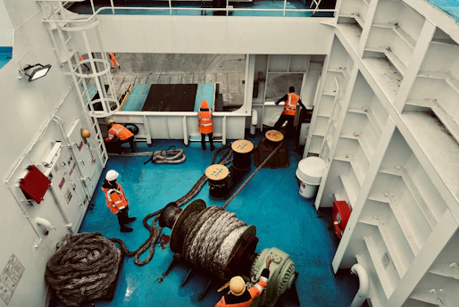 A large ship with workers and equipment inside of it