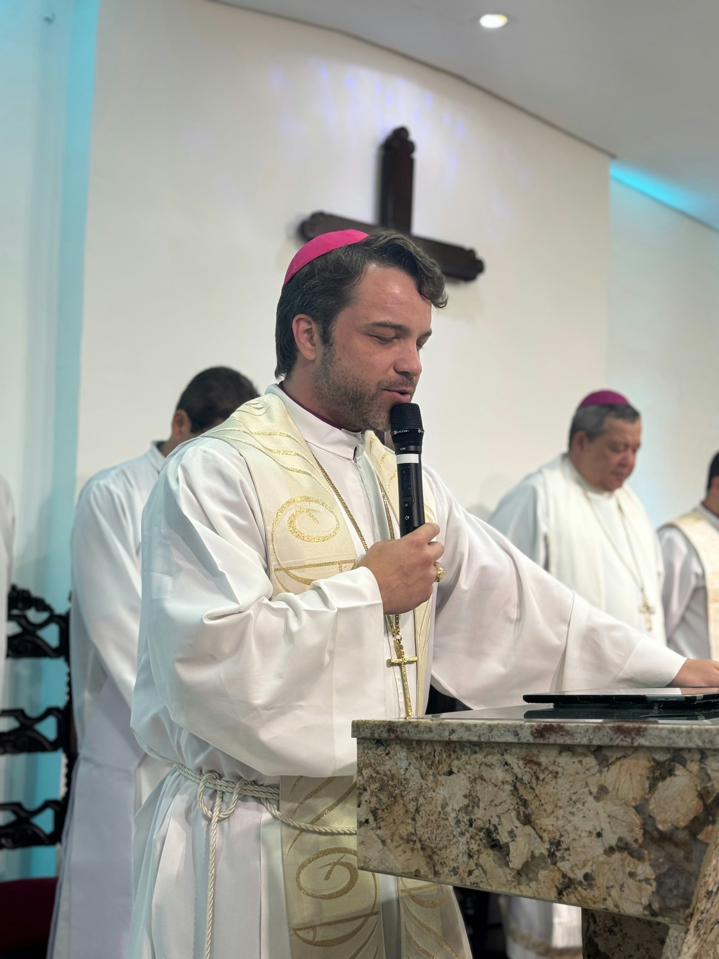 Bishop speaking at a Catholic conference, cathedral interior, warm candlelight, golden altar