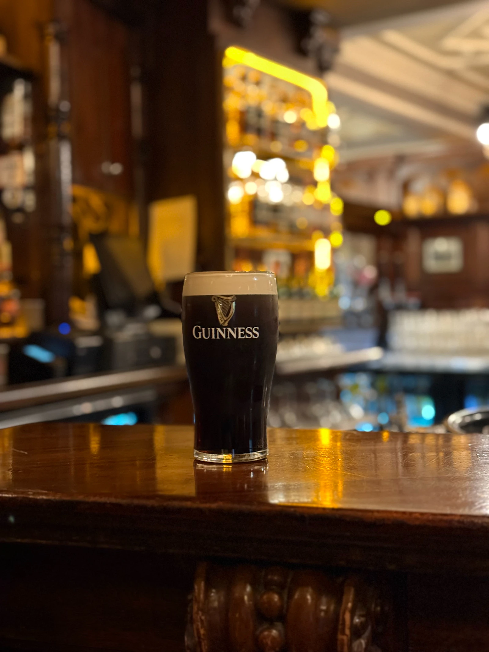 A pint of Guinness on a bar in a pub