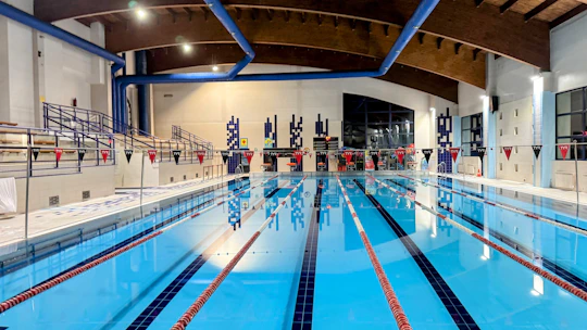 An indoor swimming pool with blue water