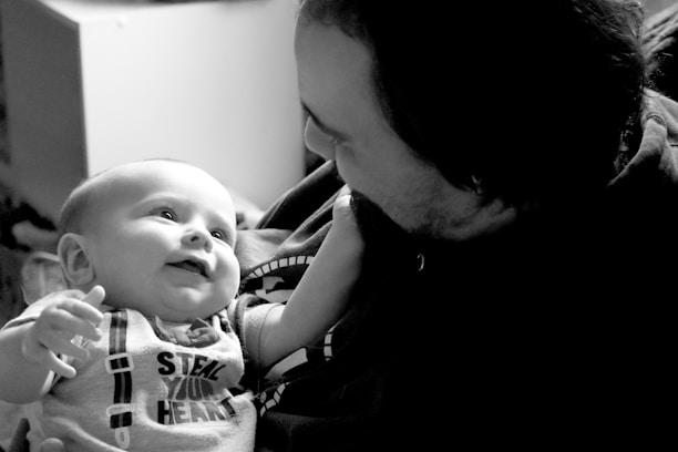 A man holding a baby in his arms