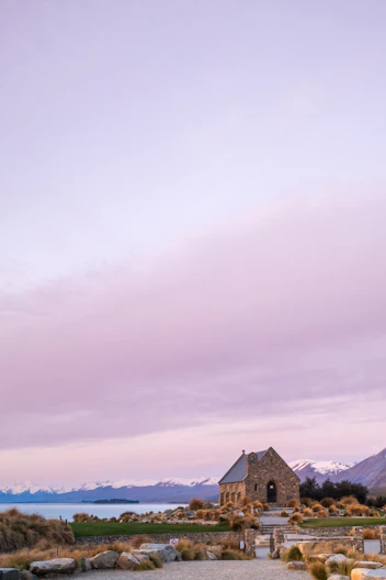 A church in the middle of a desert with mountains in the background