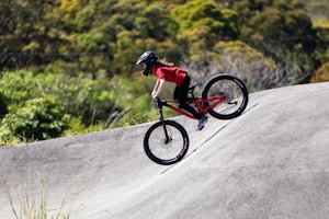 A man riding a bike up the side of a ramp