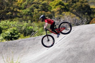A man riding a bike up the side of a ramp