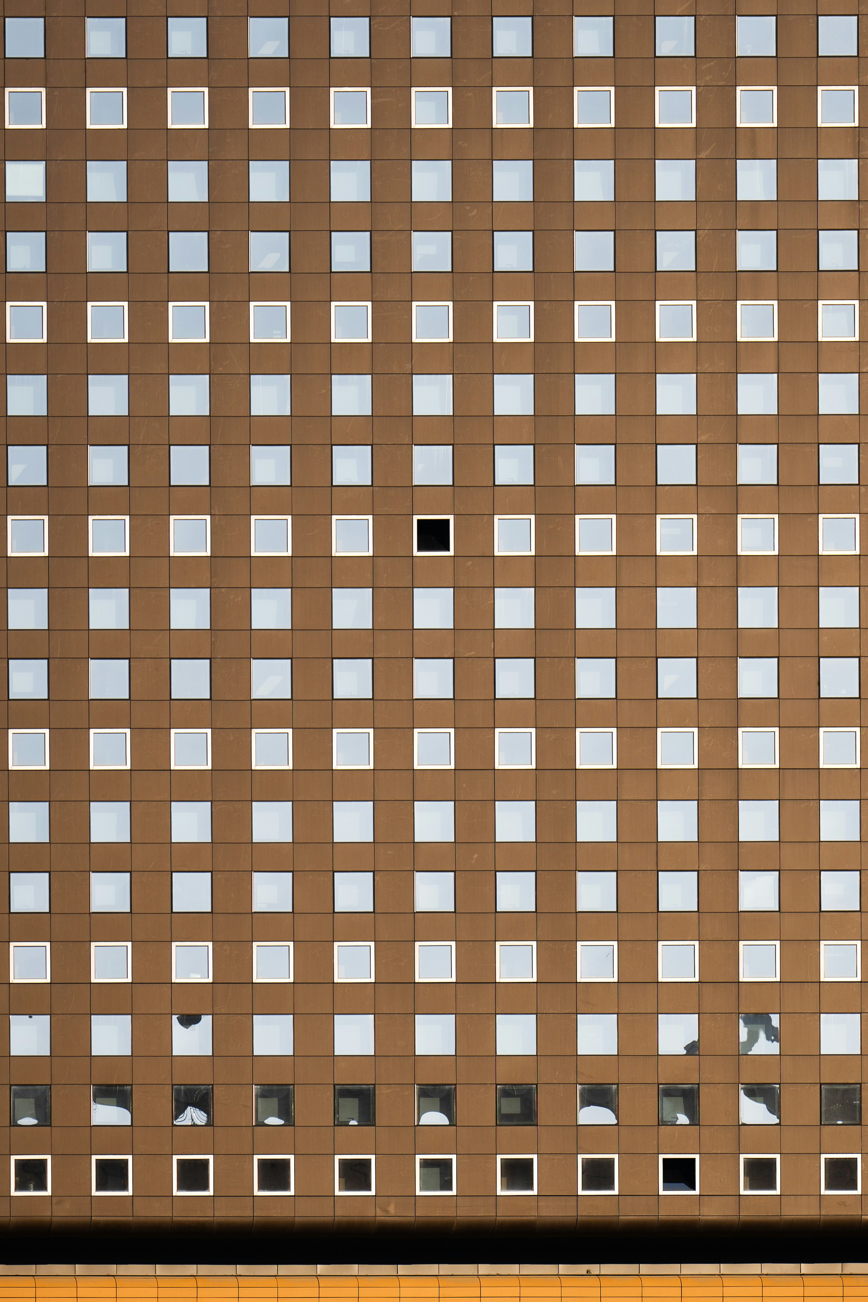 A tall building with lots of windows and a clock