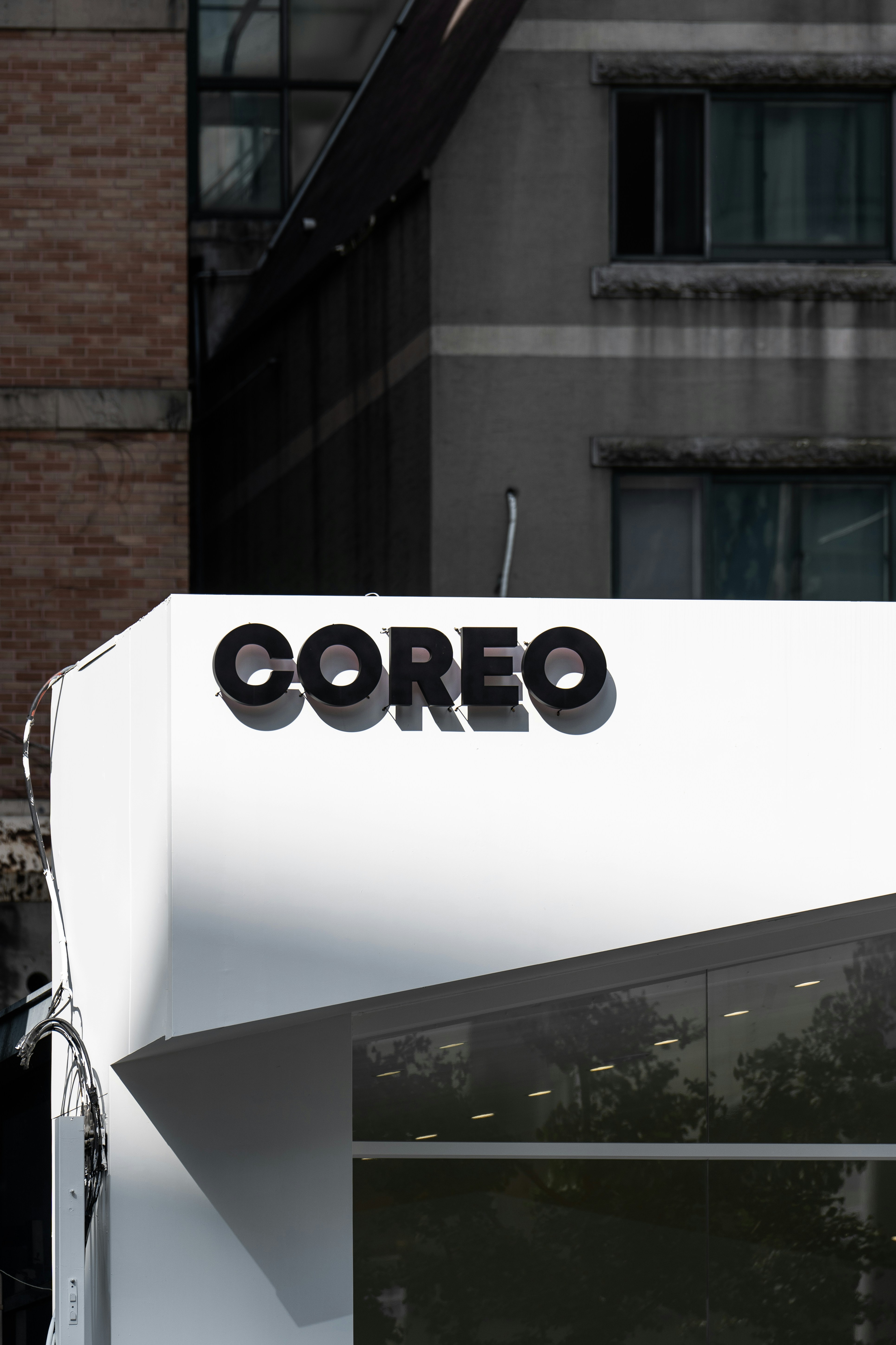 A sign that says coreo on the side of a building