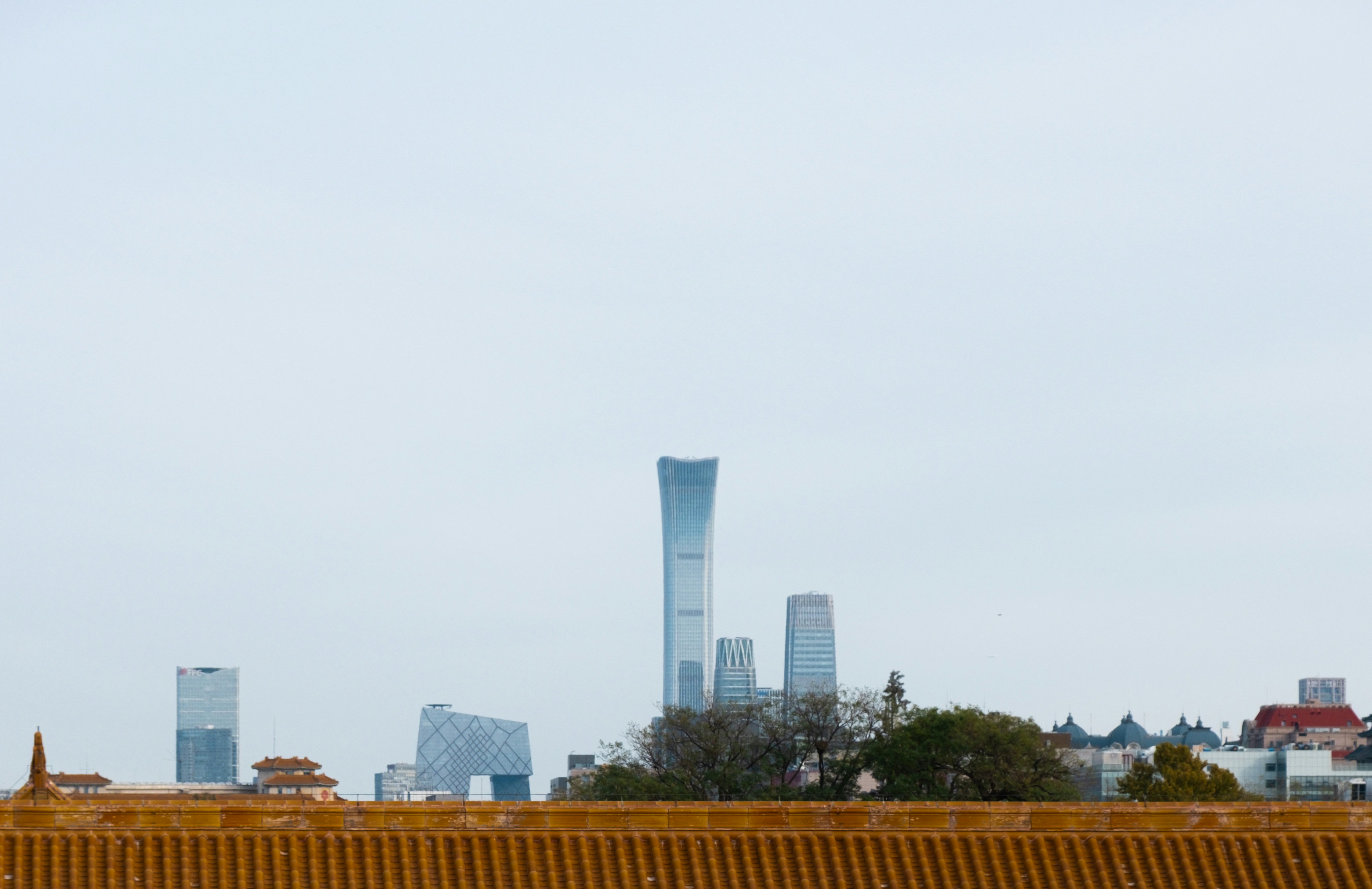 A man riding a skateboard on top of a cement wall