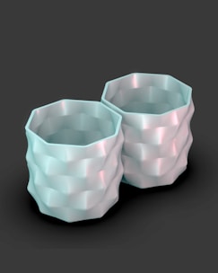 A couple of white cups sitting next to each other