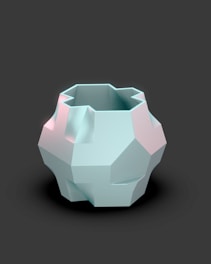 A white vase sitting on top of a black table