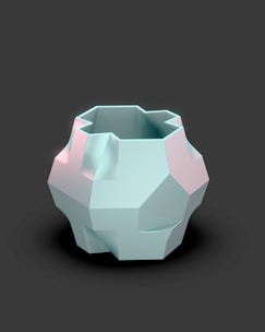 A white vase sitting on top of a black table