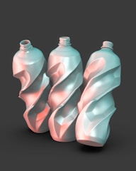 A group of three plastic bottles sitting next to each other