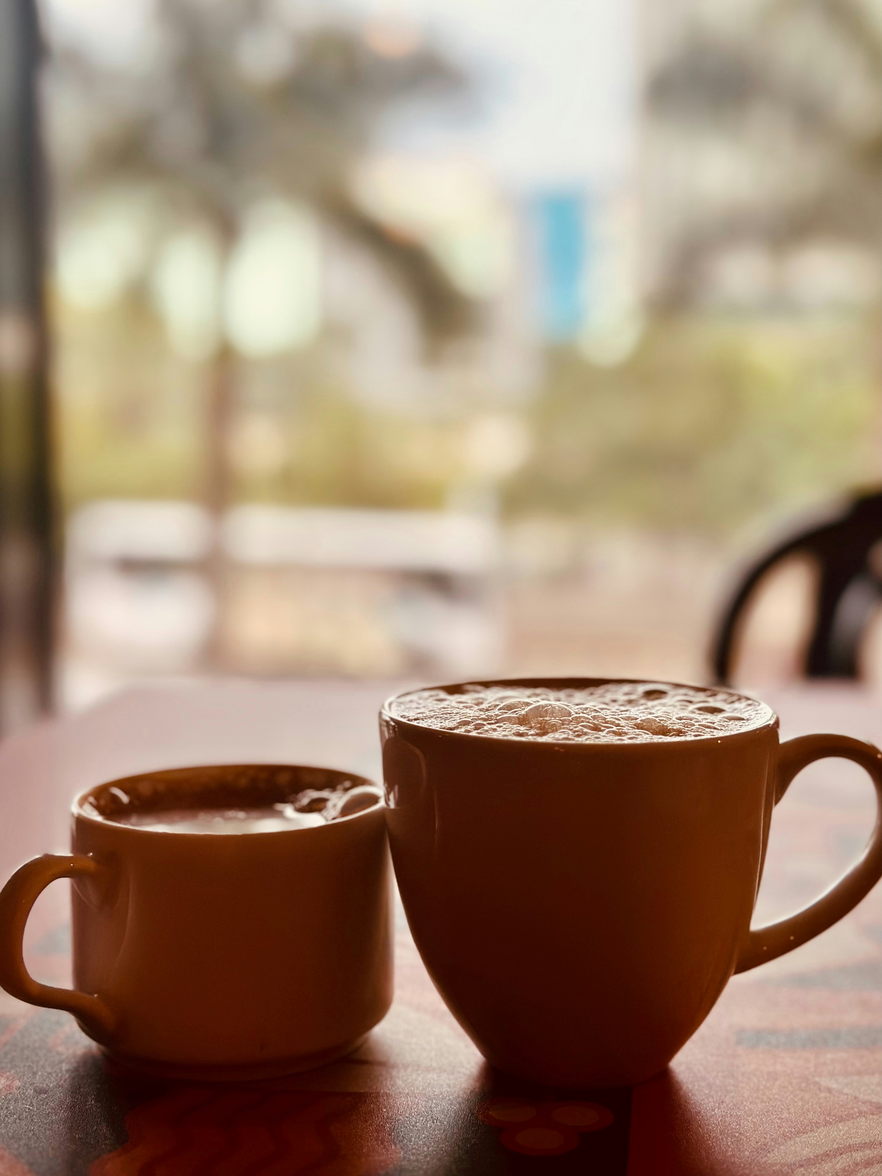 A cup of coffee sitting on top of a wooden table
