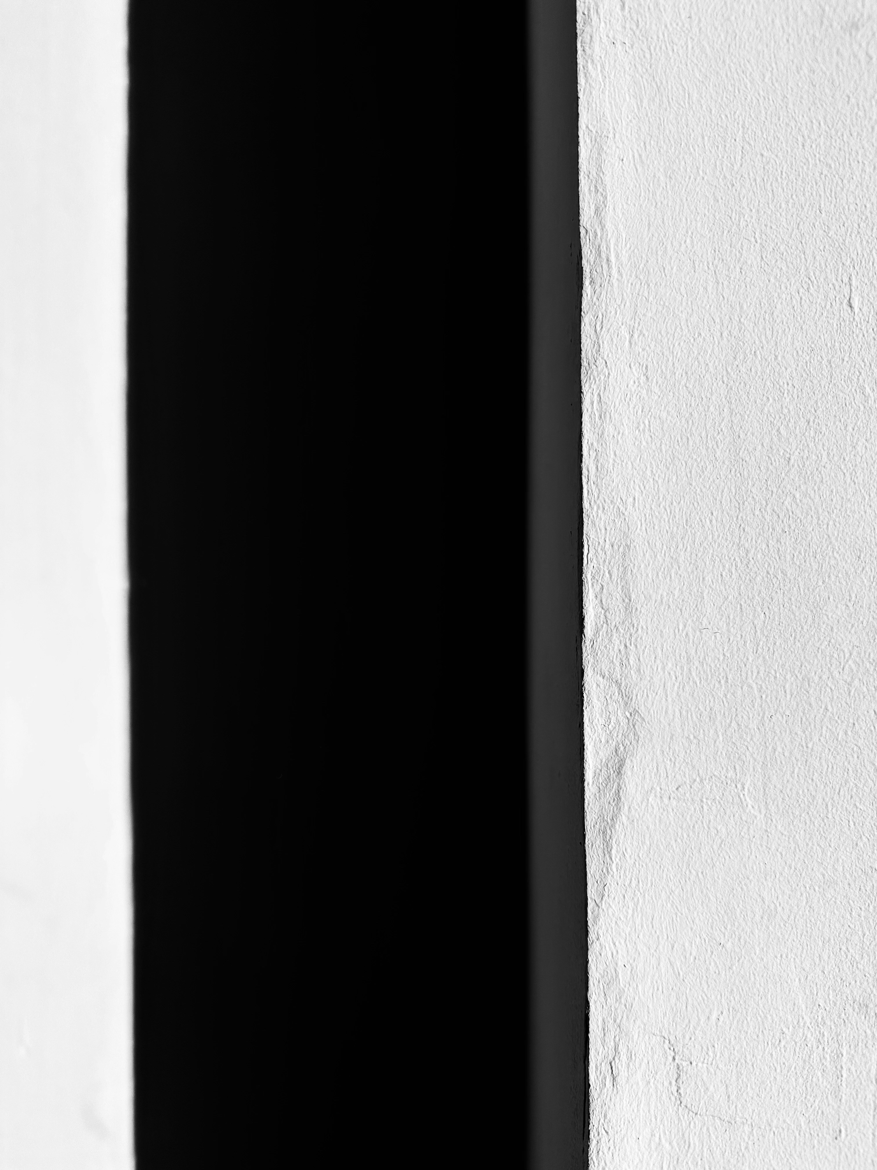 A black and white photo of a clock on a wall