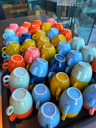 A bunch of colorful teapots sitting on a table