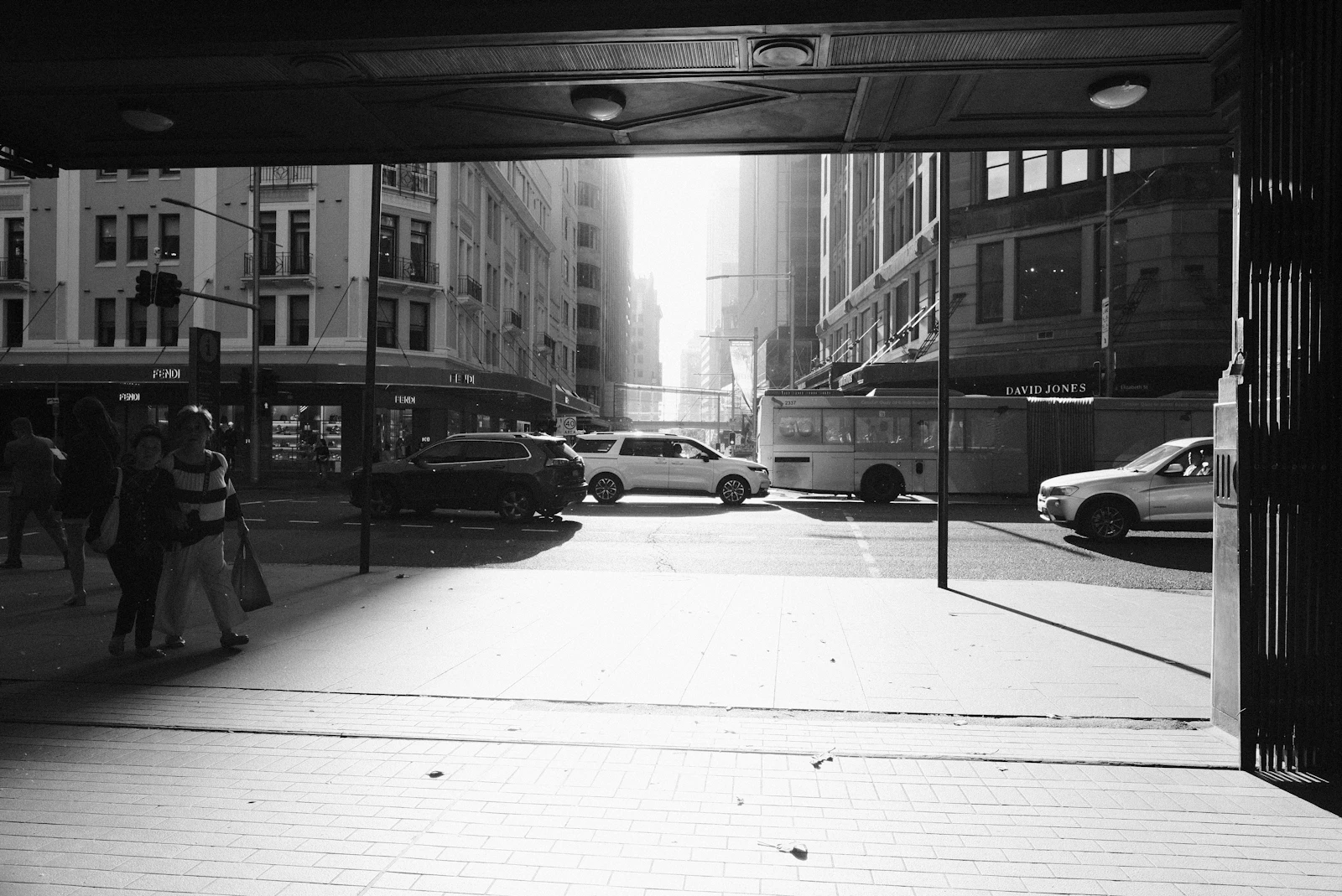 Black and white photograph of a city street with pedestrians
