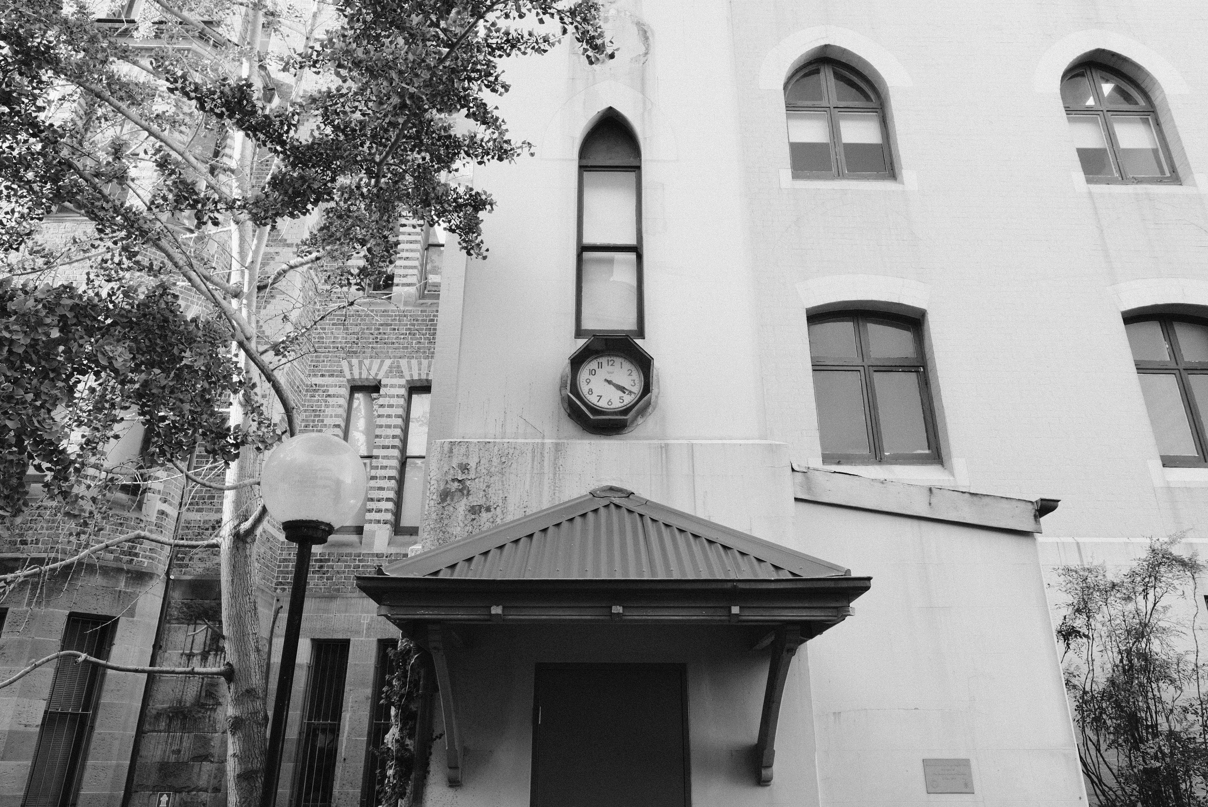 Black and white view of a heritage building with a wall clock