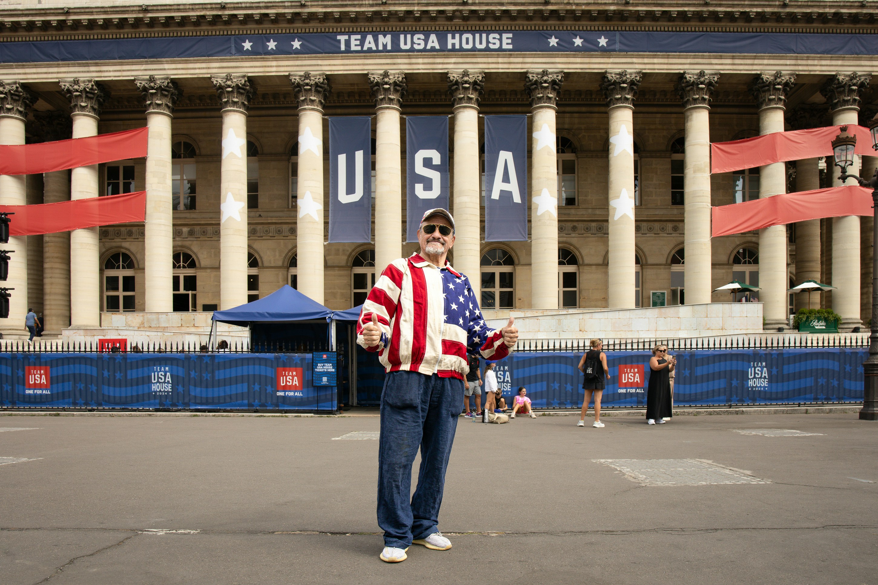 A man standing in front of a large building