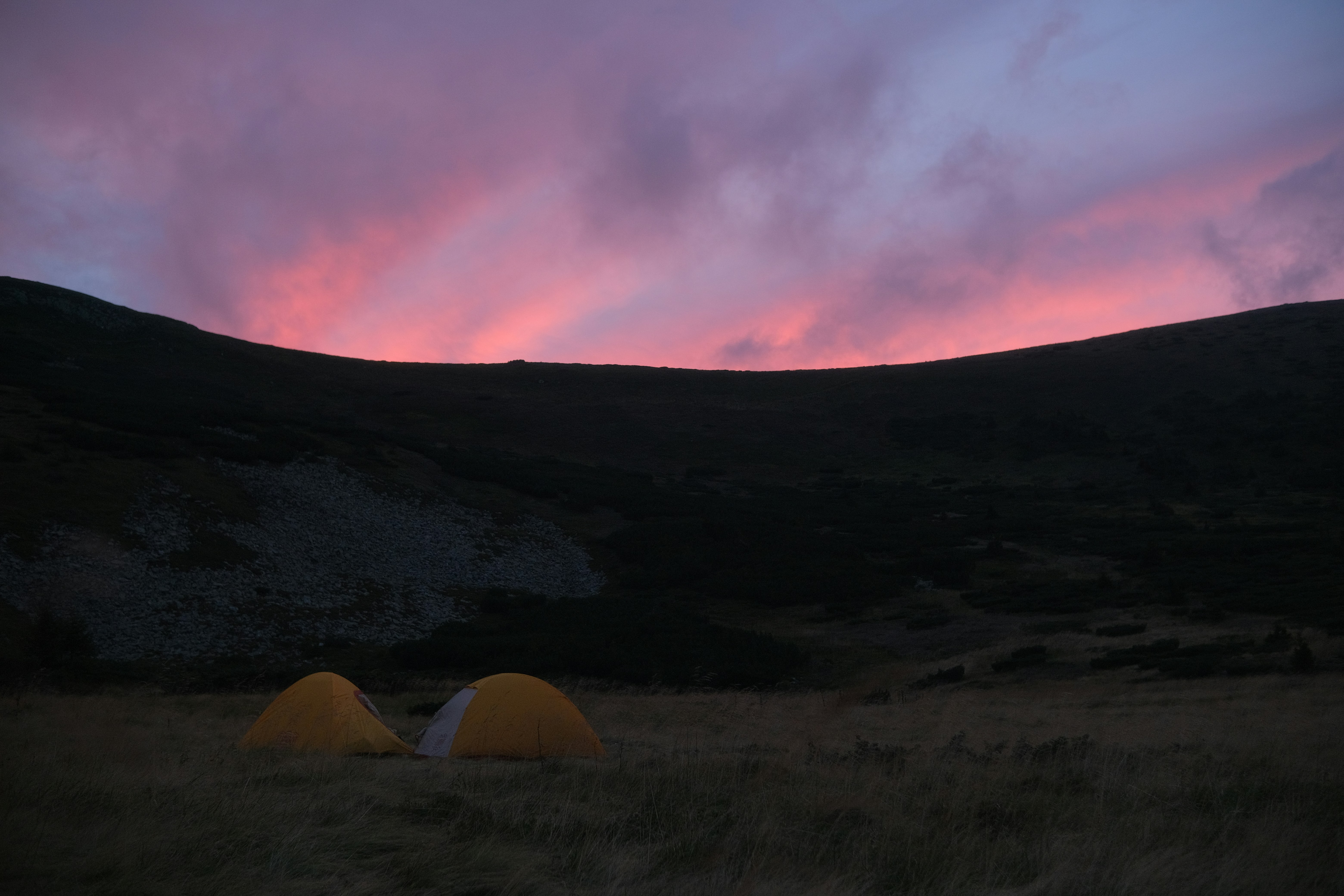 A couple of tents sitting on top of a grass covered field