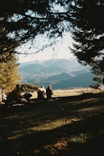 A group of people sitting on top of a grass covered field