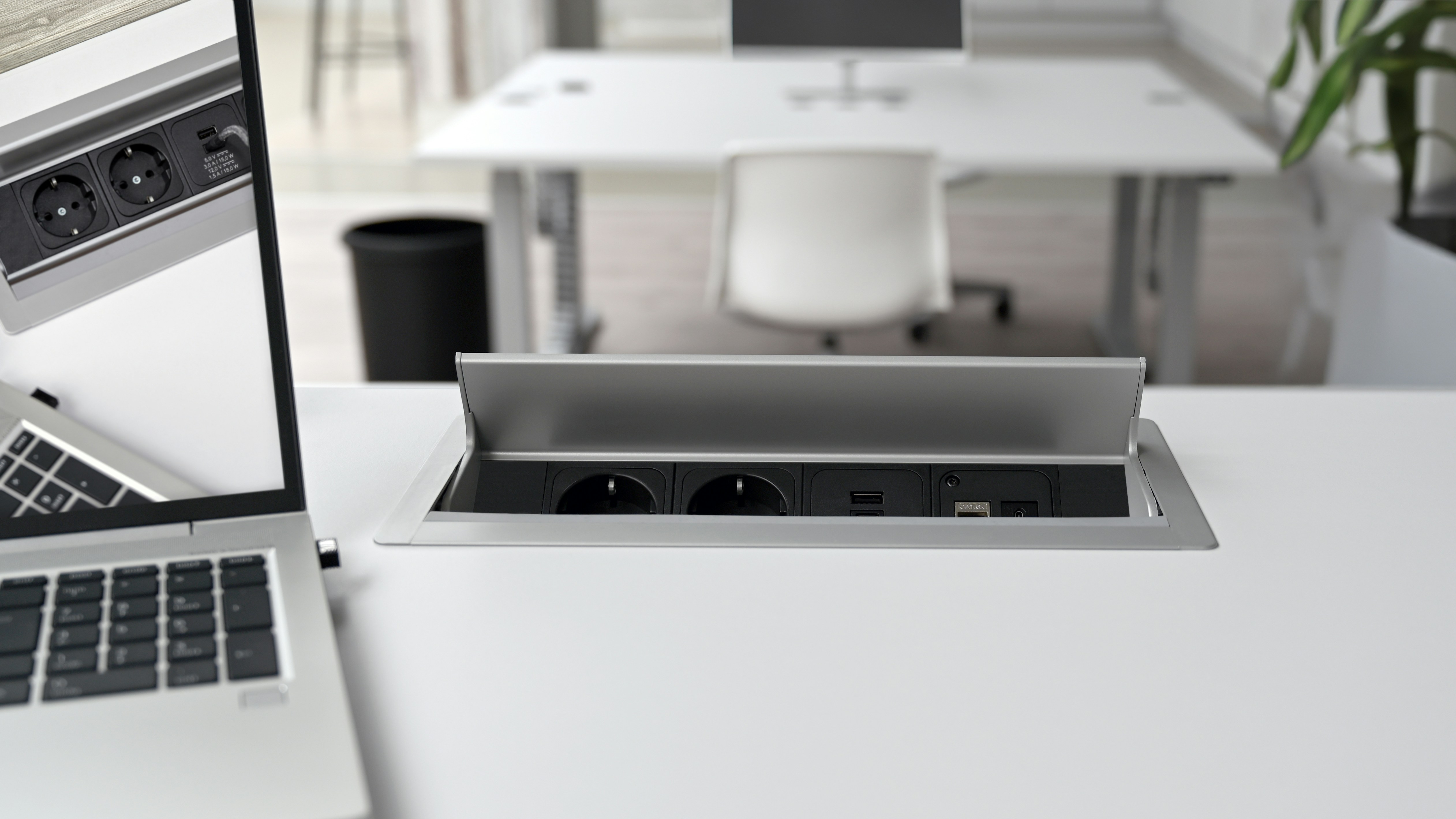 Ein Laptop sitzt auf einem weißen Tisch