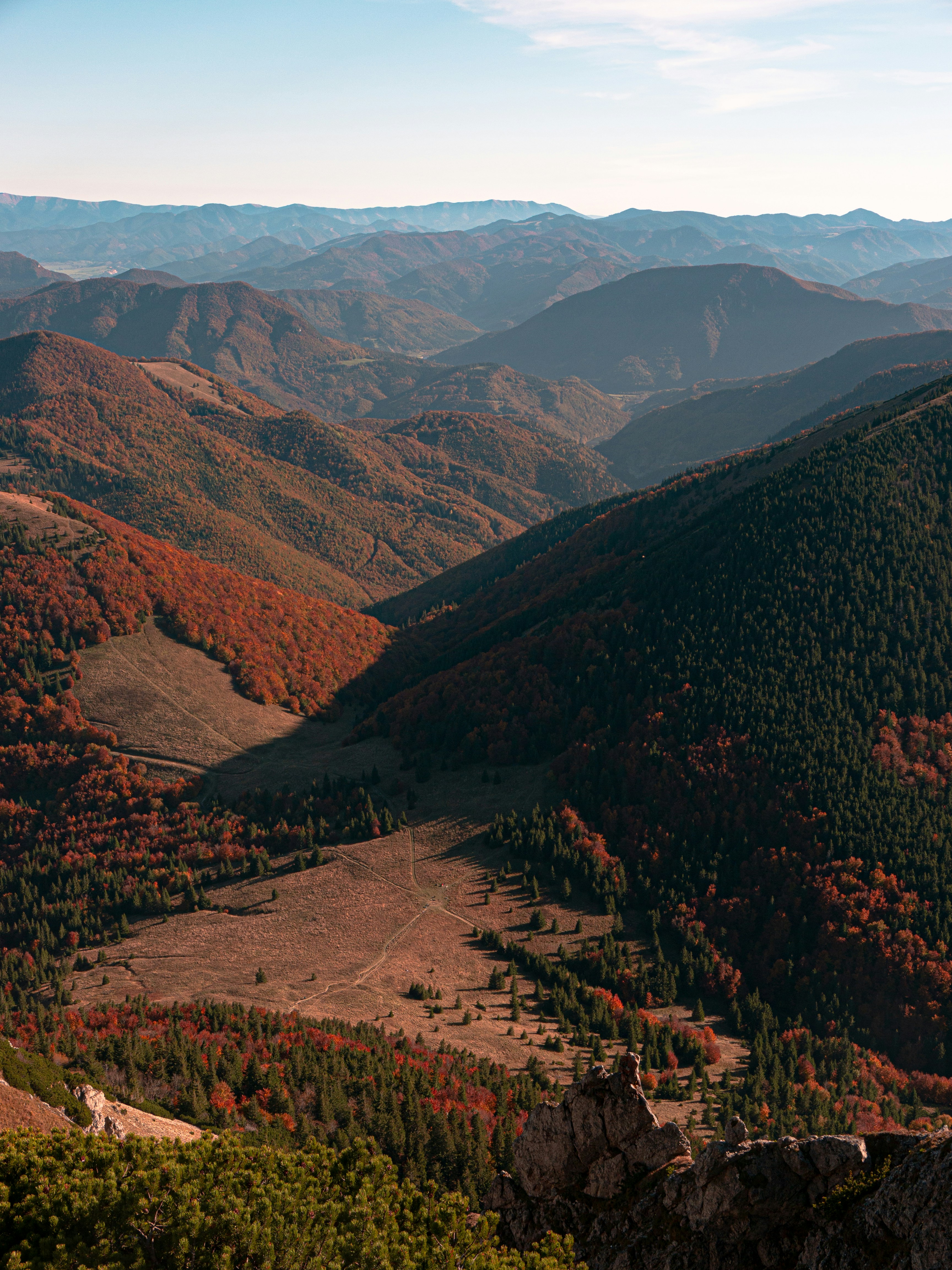 A view of a valley with mountains in the background