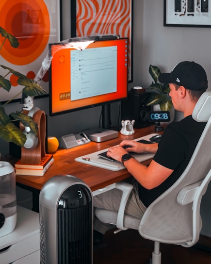 A man sitting at a desk with a computer