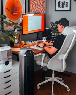 A man sitting at a desk in front of a computer