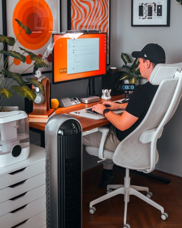 A man sitting at a desk in front of a computer