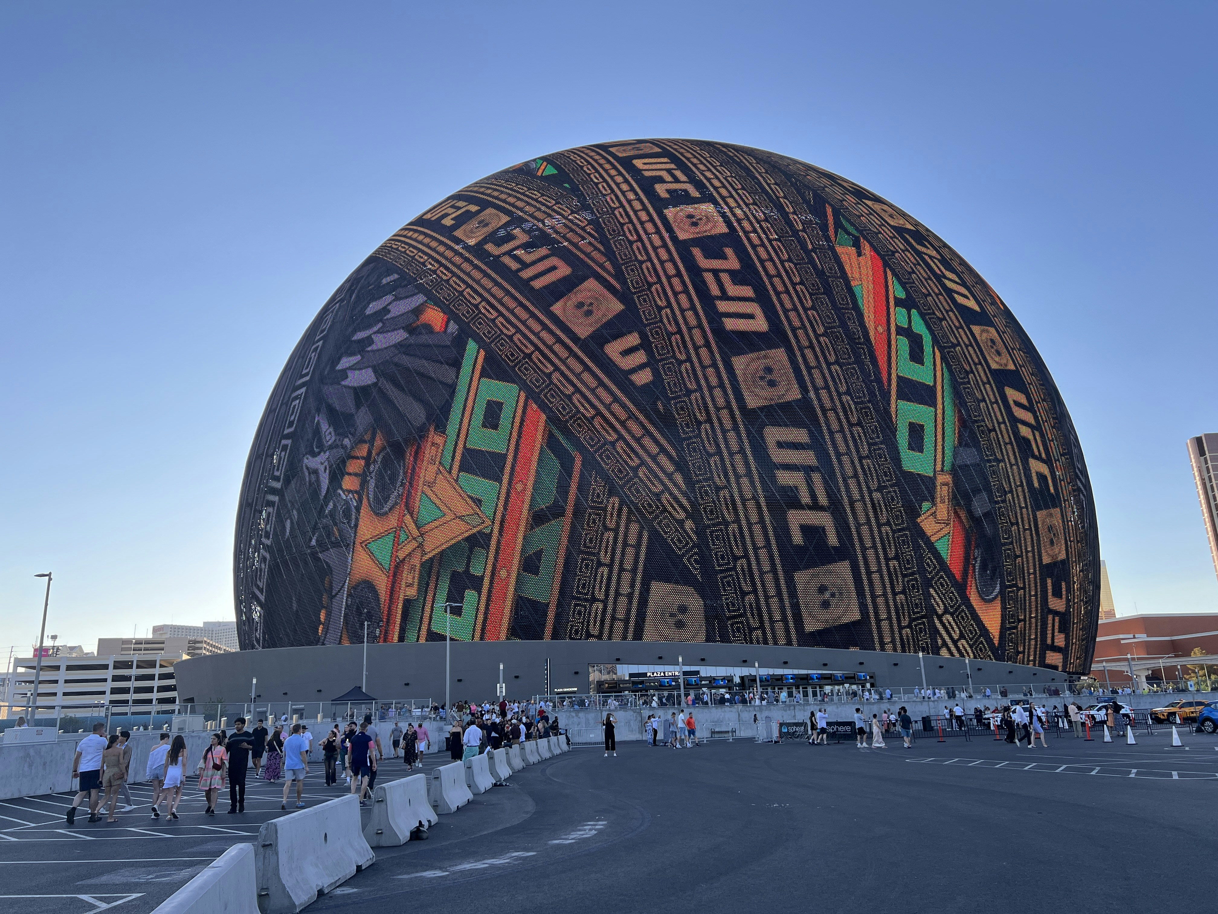 A large building with a lot of people standing around it