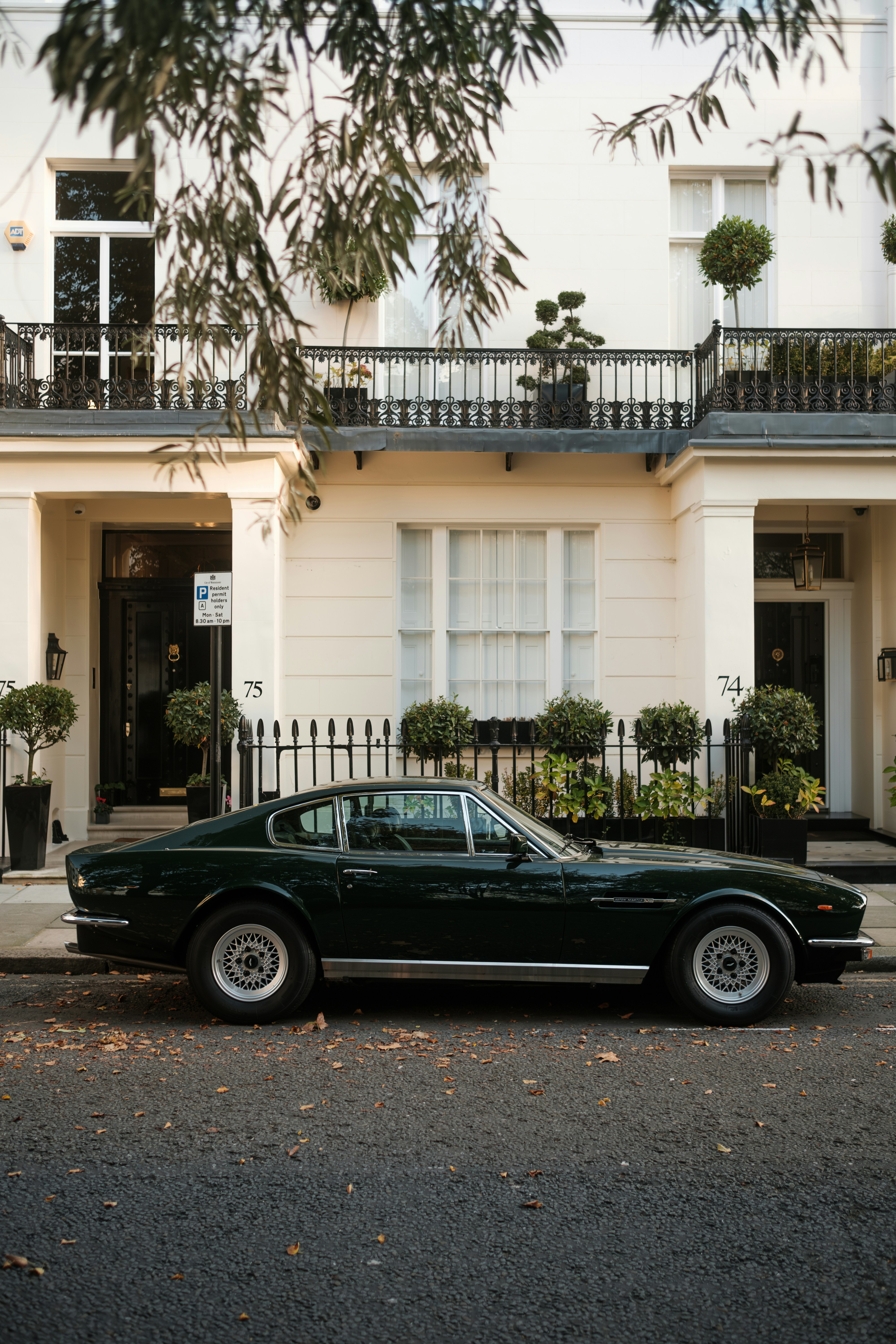A black car parked in front of a white building
