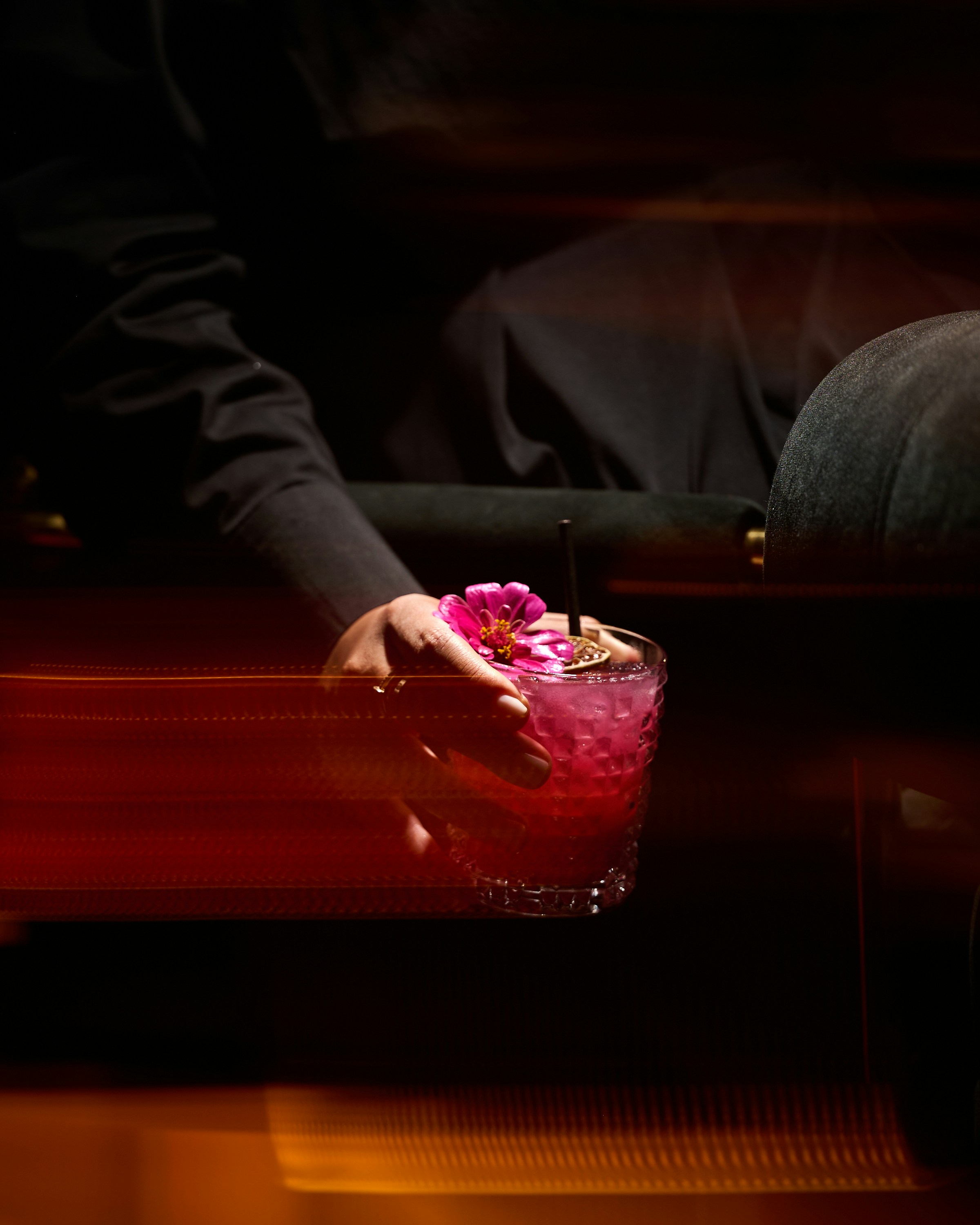 A person holding a drink in their hand