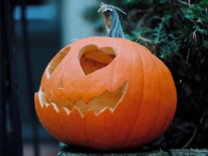 A carved pumpkin sitting on top of a wooden table
