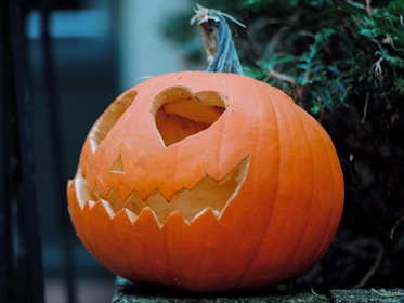 A carved pumpkin sitting on top of a wooden table