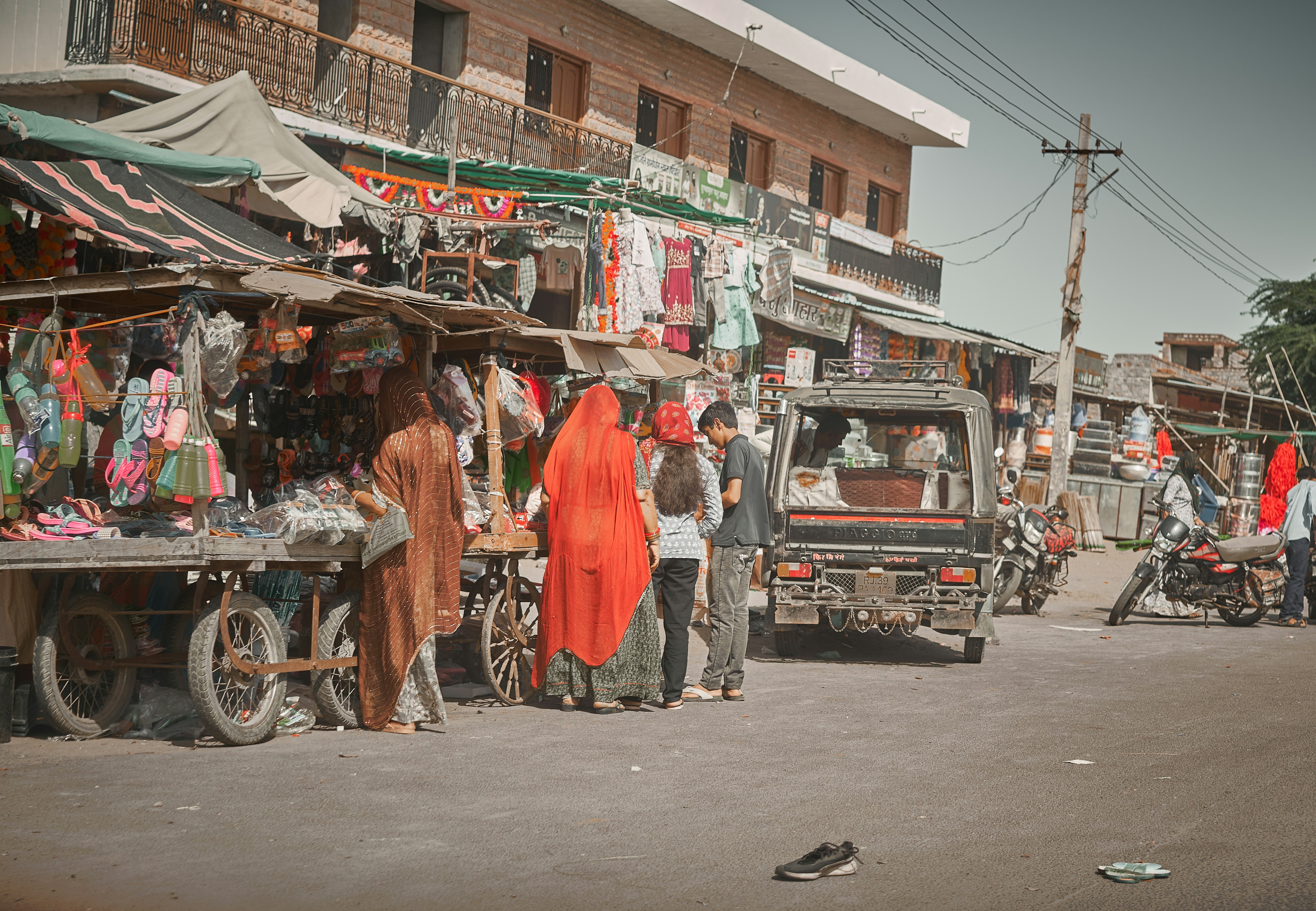 A group of people standing around a market