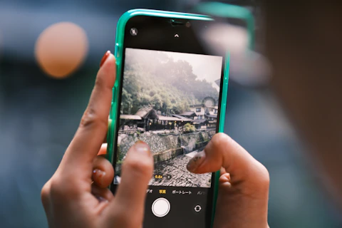 A person taking a picture with a cell phone