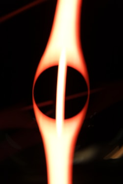 A close up of a flame with a black background