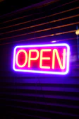 A neon sign that says open on it
