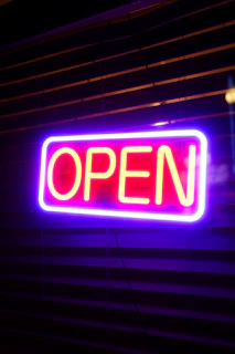 A neon sign that says open on it
