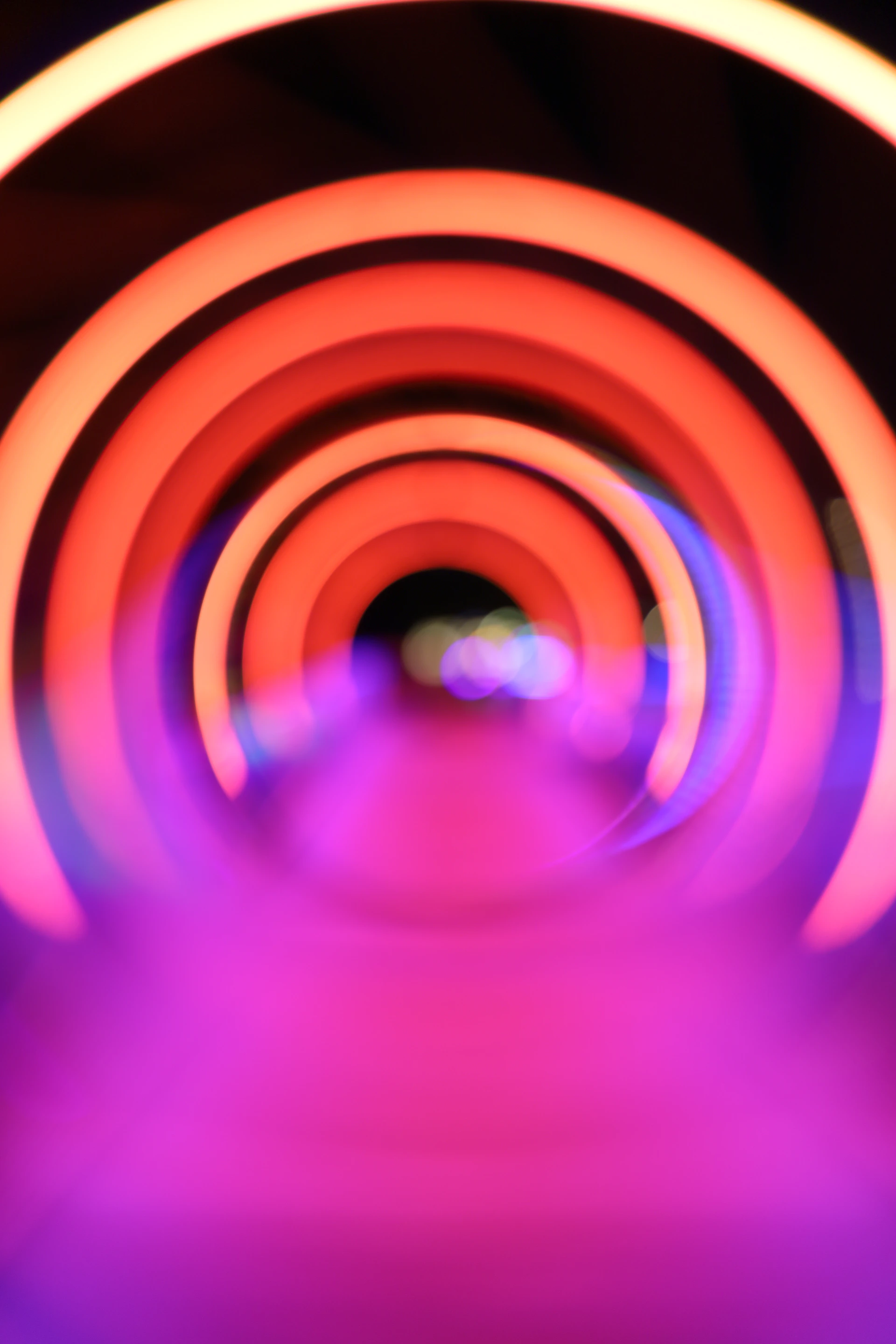 A blurry photo of a tunnel with a light at the end