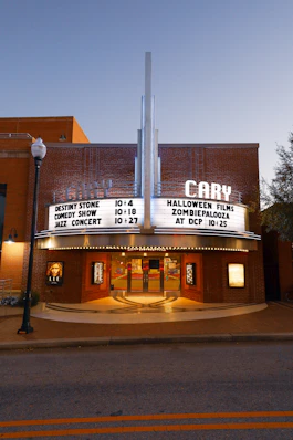 A movie theater with a large sign on the front of it