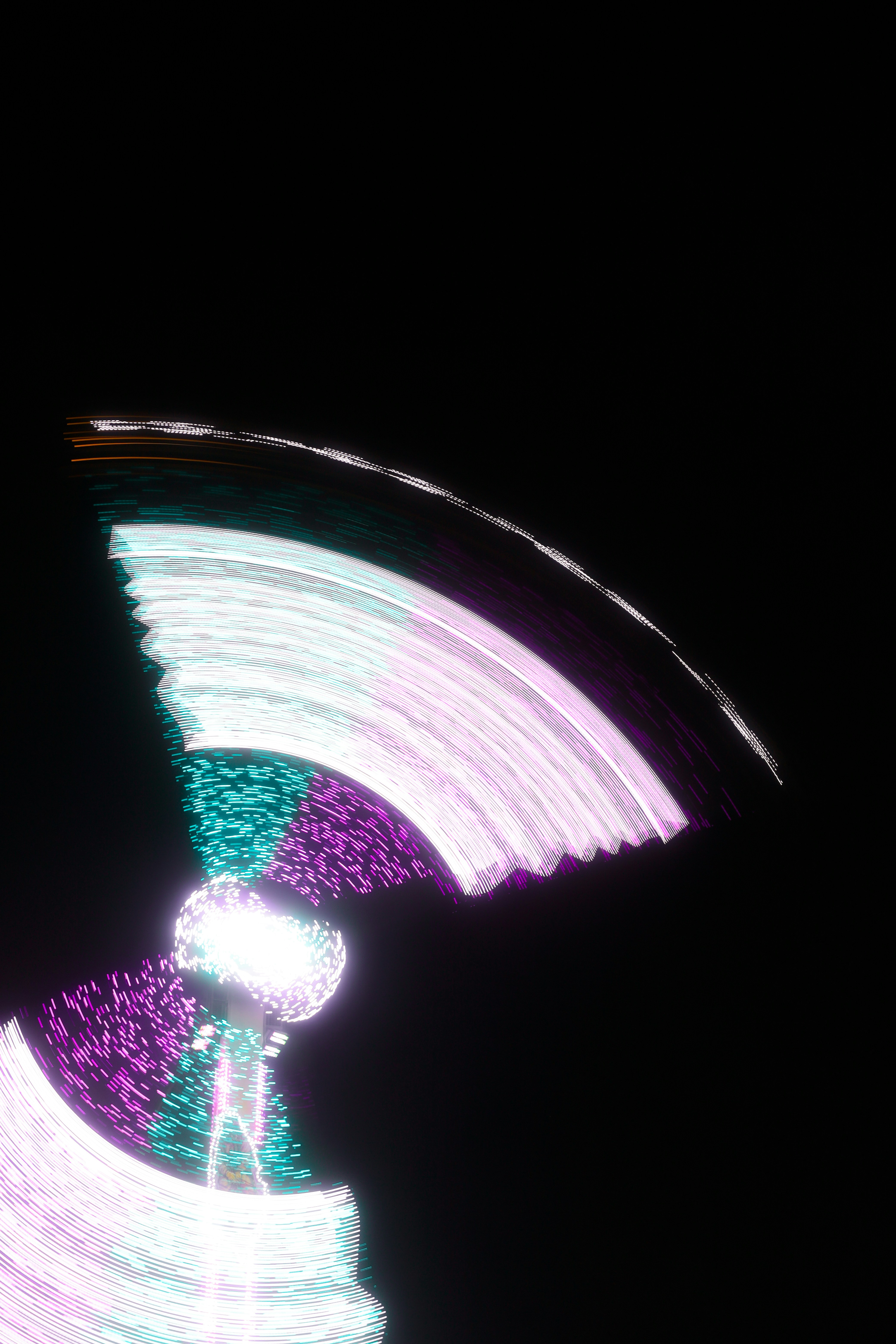 A blurry photo of a ferris wheel at night