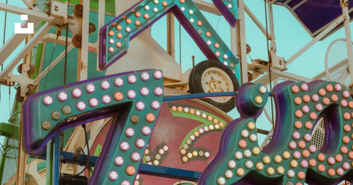 A carnival ride with a large sign on top of it photo – Free North ...