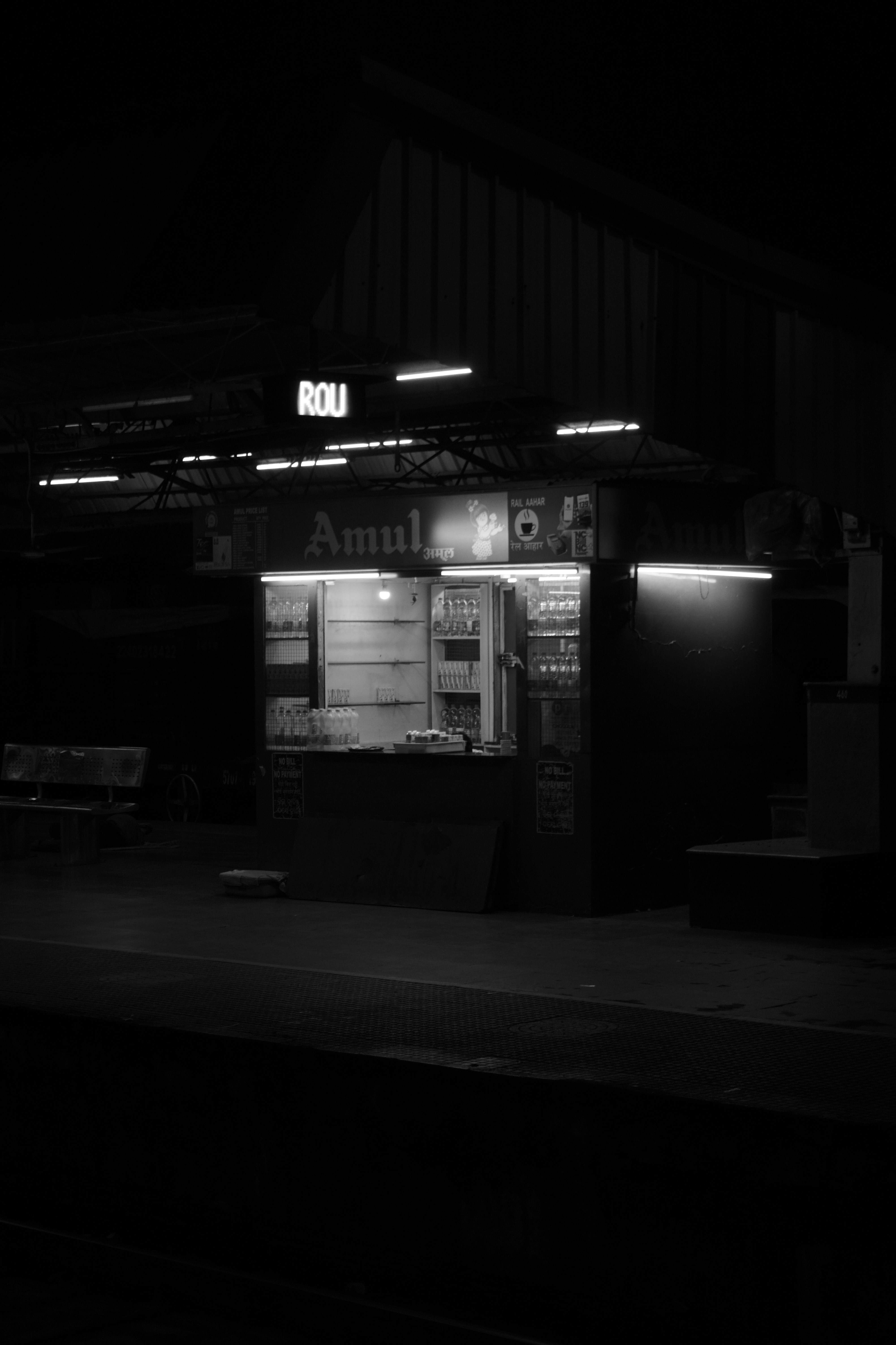 A black and white photo of a gas station at night