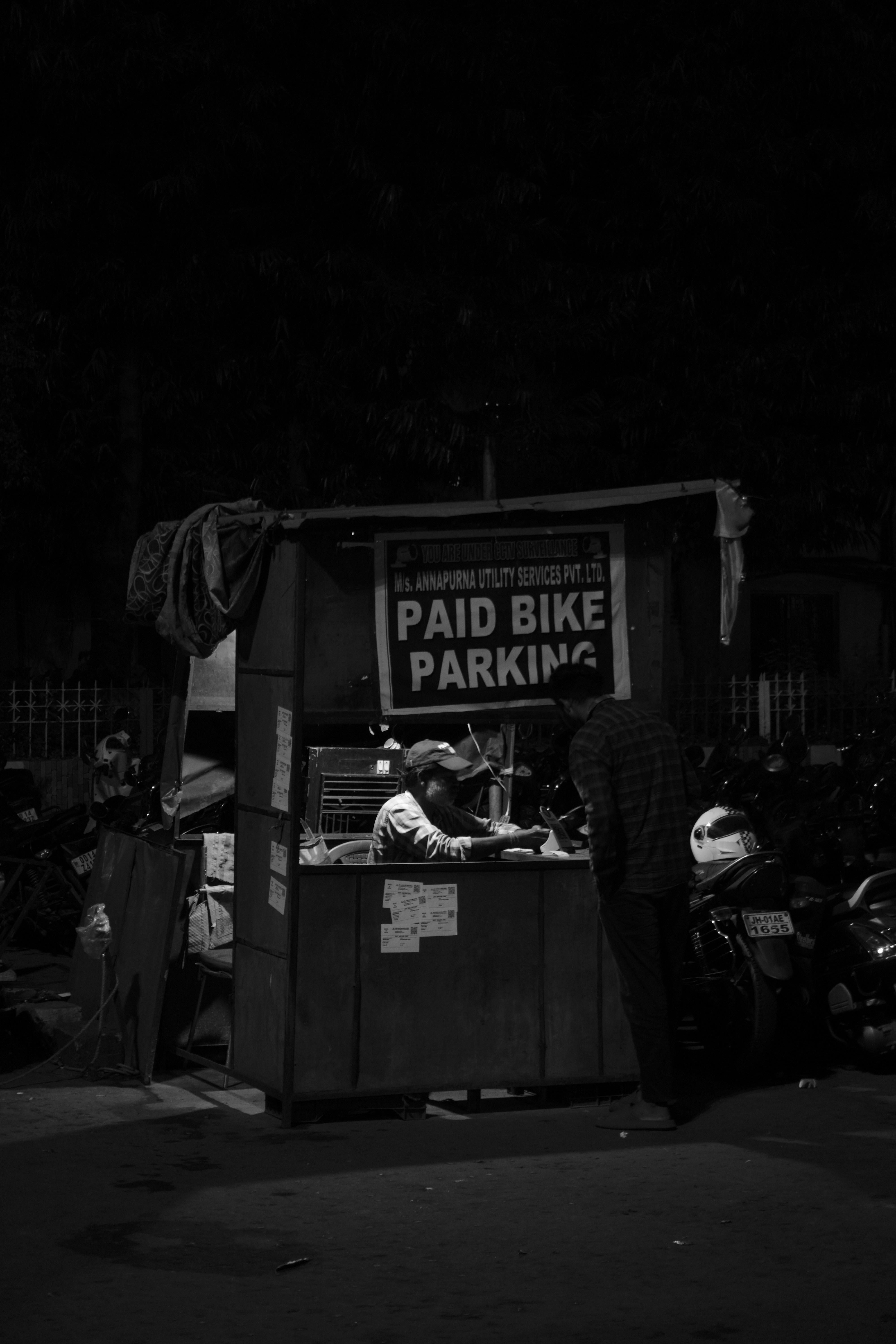 A black and white photo of a bike parking booth