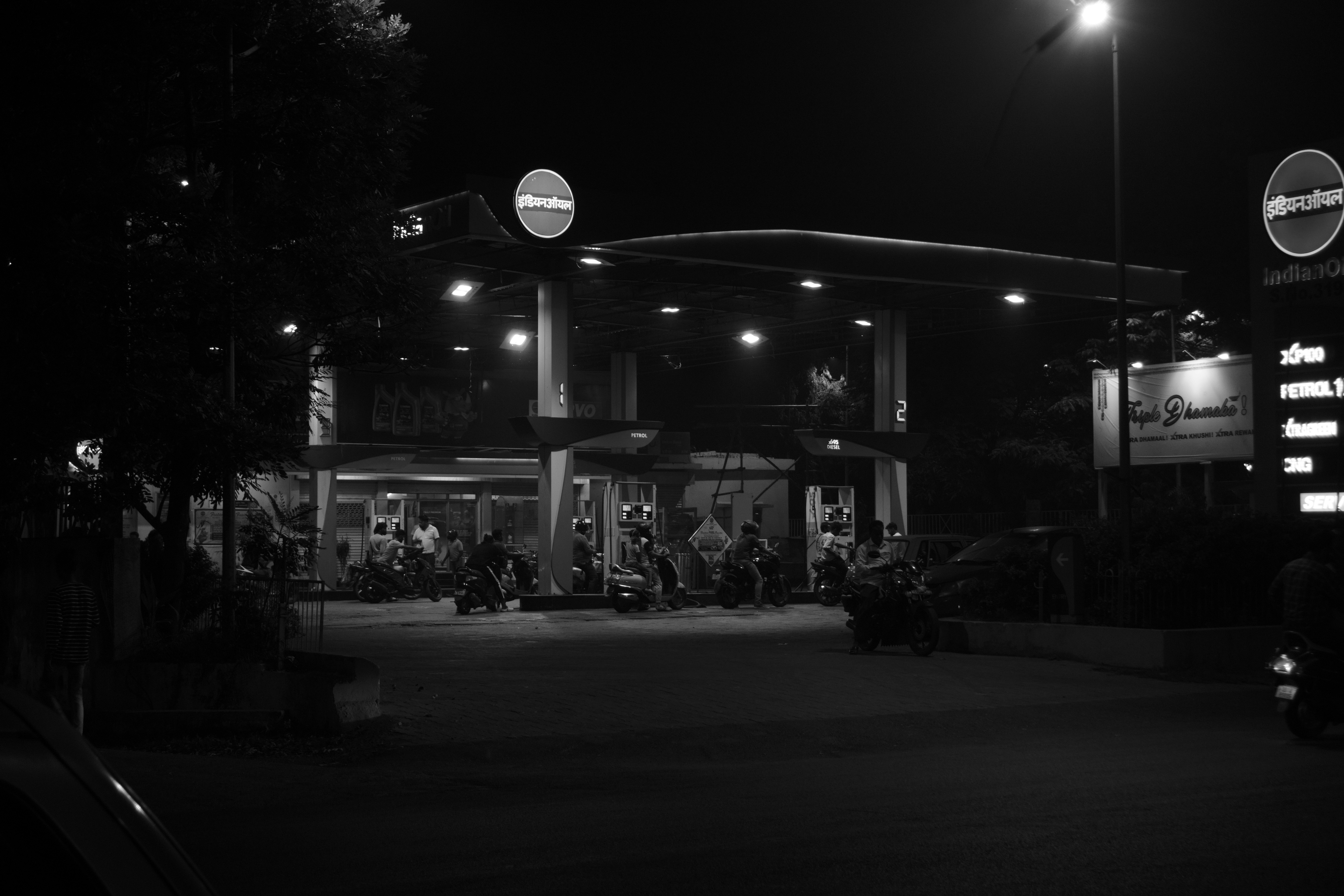 A black and white photo of a gas station at night